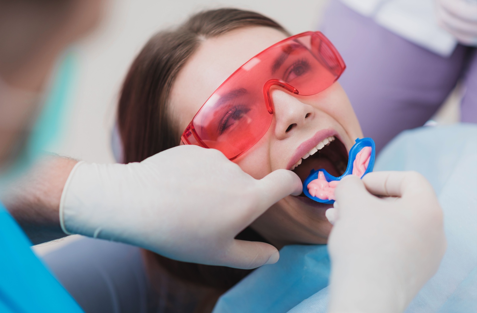 A dentist performs a fluoride rinse