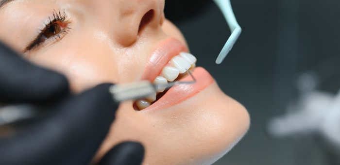 A dentist performs a dental cleaning