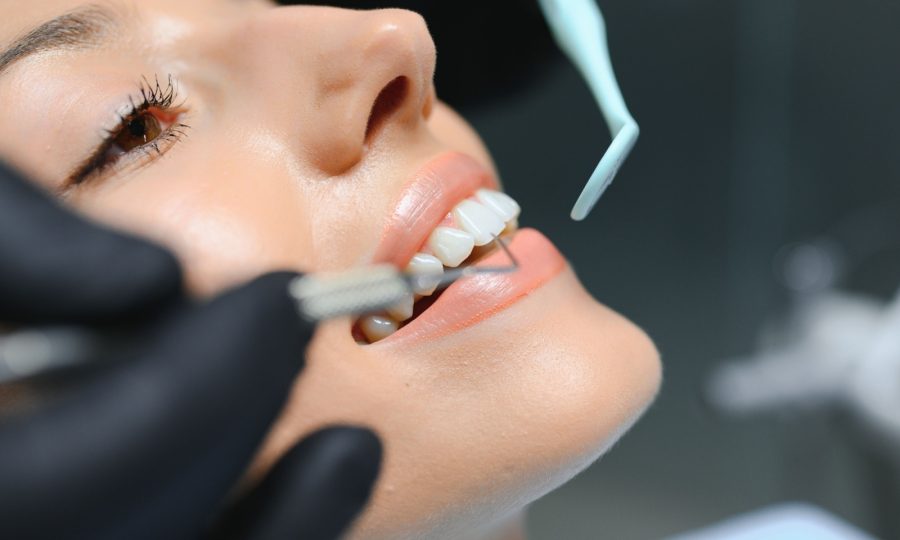 A dentist performs a dental cleaning